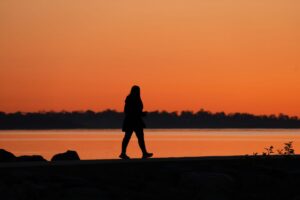 person walking during a sunset